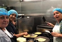 Volunteers at RAIN (Resourceful Australian Indian Network) preparing meals for affected community members.