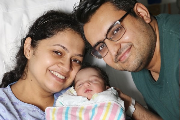 Parents Alisha and Kshitij with baby Ruaan. (Image supplied)